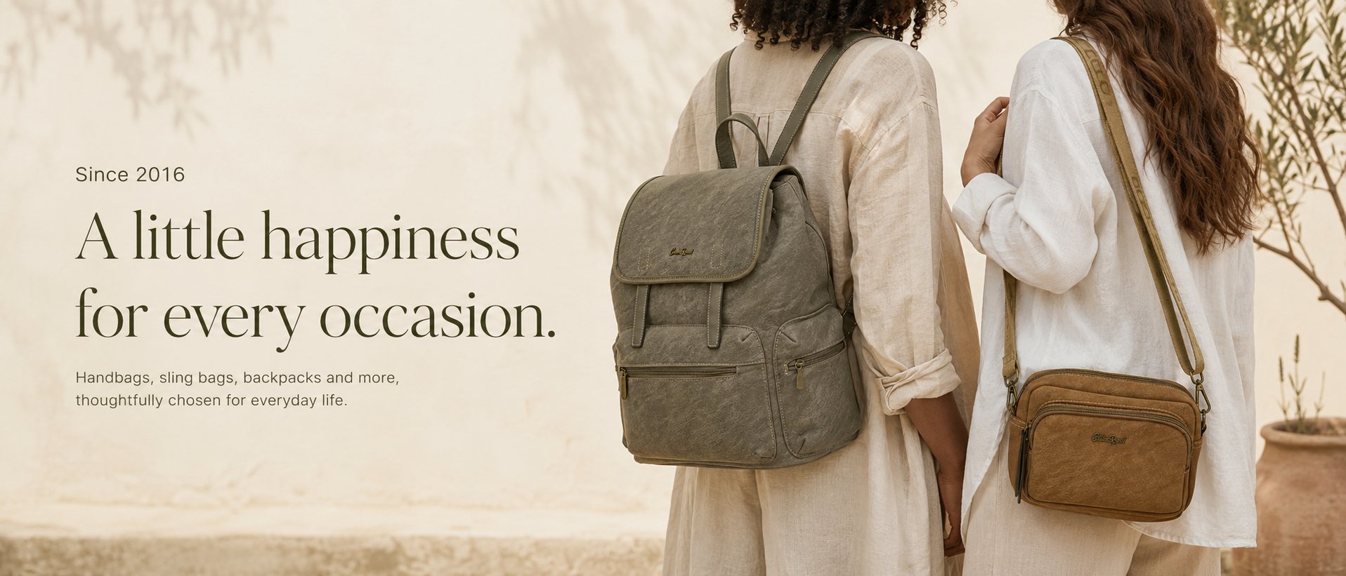 Two women in linen outfits carrying an olive backpack and a tan sling bag in warm natural light — a little happiness for every occasion, since 2016
